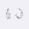 Boucles d&rsquo;oreilles créoles aux formes fluides et sculpturales