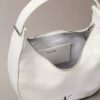 Petit sac à bandoulière convertible aux lignes courbes