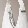 Petit sac à bandoulière convertible aux lignes courbes